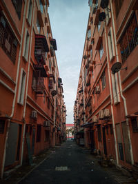 Narrow street amidst buildings in city