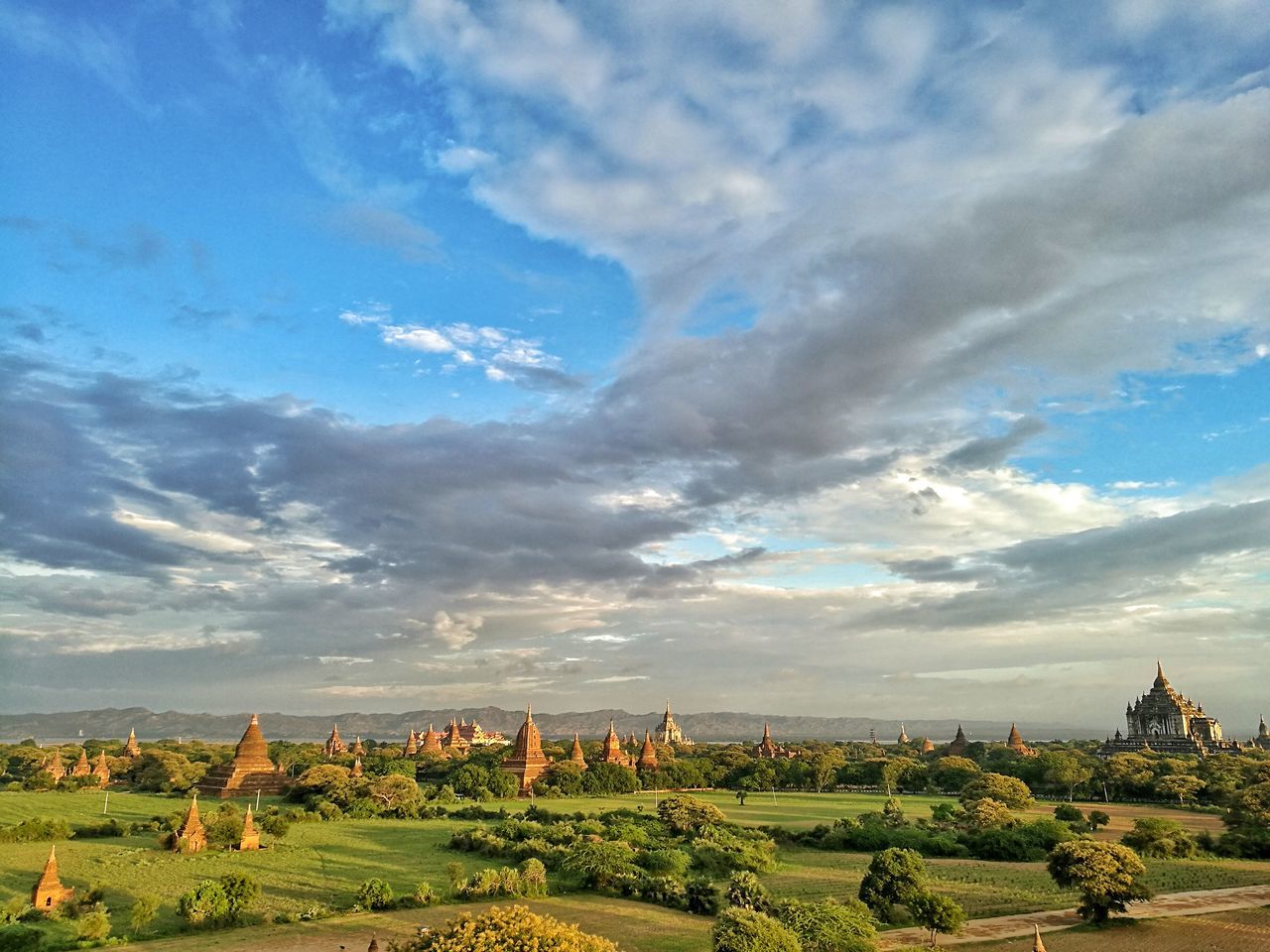 landscape, sky, cloud - sky, tree, travel destinations, tranquil scene, growth, day, blue, scenics, plant, tranquility, sunny, outdoors, tourism, beauty in nature, green color, cloudy, nature, agriculture, farm, garden, plantation, no people, cultivated land