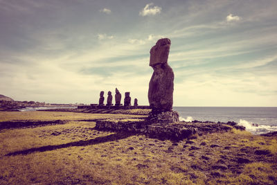 View of rocks on beach against sky