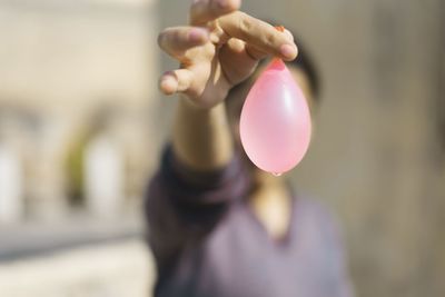 Close-up of hand holding balloons