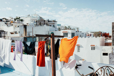 Clothes drying on clothesline against buildings in town