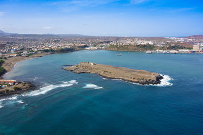 Aerial view of sea and city against sky