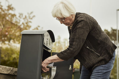 Senior woman standing near mailbox