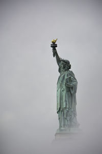 Low angle view of statue against sky