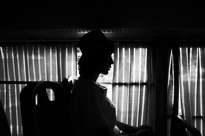 Side view of young woman sitting in bus