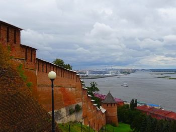 High angle view of townscape by sea against sky