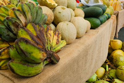 Green fruits for sale at market stall