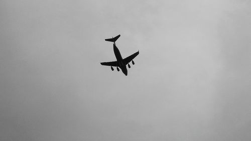 Low angle view of helicopter flying in sky