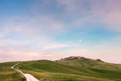 Scenic view of land against sky during sunset