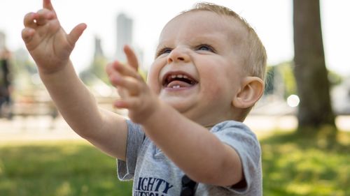 Close-up of cute boy laughing while looking away