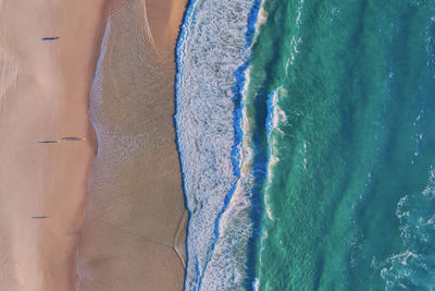 High angle view of waves splashing at shore