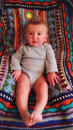 Cute baby girl lying on bed