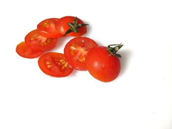Close-up of red chili peppers over white background