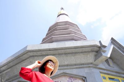 Woman at temple against sky