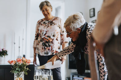 Senior woman pouring champagne