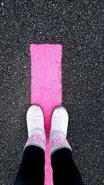 Low section of person standing on road