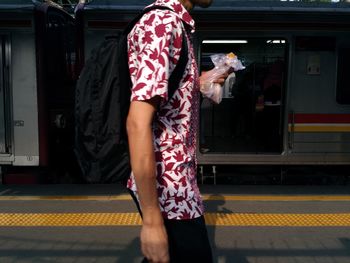 Full length of woman standing at railroad station