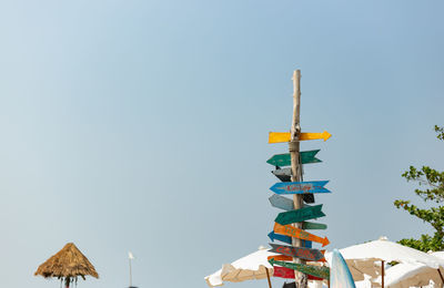 Colorful wooden road signs on the beach. direction board on the beach.