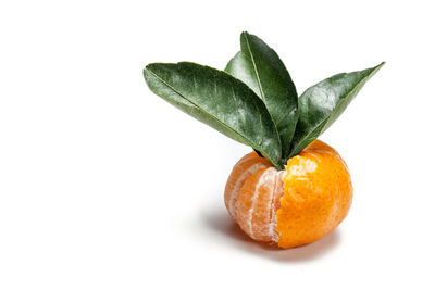 Close-up of orange slice over white background