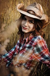 Portrait of woman wearing hat standing outdoors