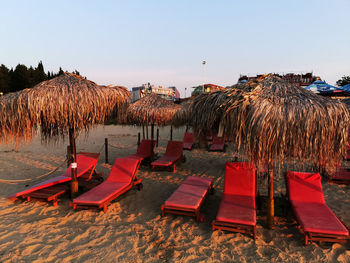 Panoramic view of parasols on beach against clear sky