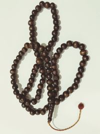 Close-up of necklace on white background