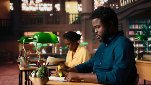 Side view of man sitting on table at restaurant