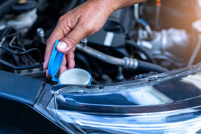 Cropped hand of man repairing car