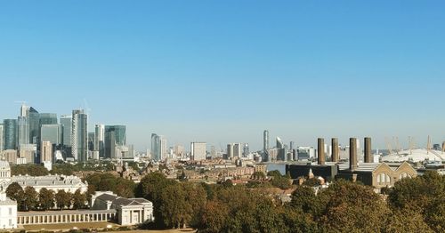 View of modern buildings against clear blue sky