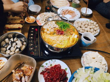 Cropped image of friends having foods at home