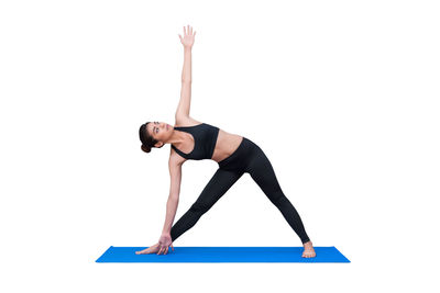 Midsection of woman with arms raised against white background