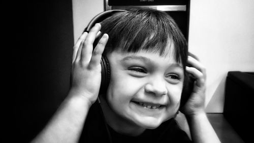 Close-up of boy listening to music at home