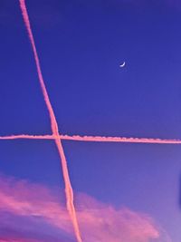 Low angle view of vapor trails in sky