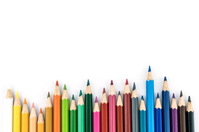 Close-up of colored pencils against white background