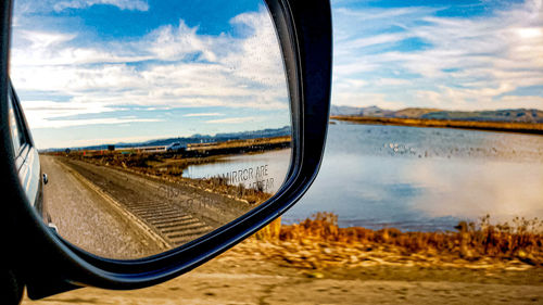 Reflection of sky on side-view mirror