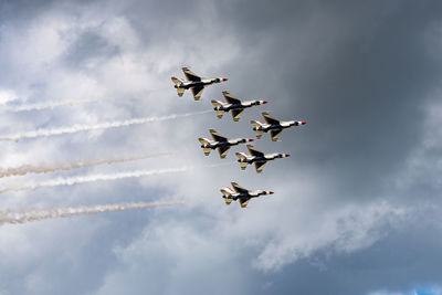 Low angle view of airshow against sky