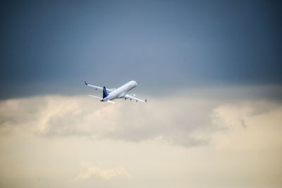 Low angle view of airplane flying in sky