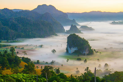 Panoramic view of trees and mountains against sky during sunset