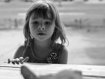 Close-up of girl looking away by table