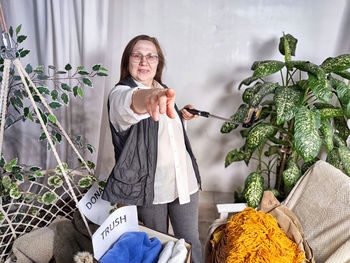 Portrait of young woman holding christmas tree