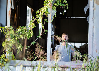 Portrait of man standing in abandoned building