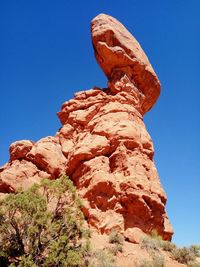 Low angle view of rock formation against blue sky