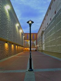 Illuminated street light against sky