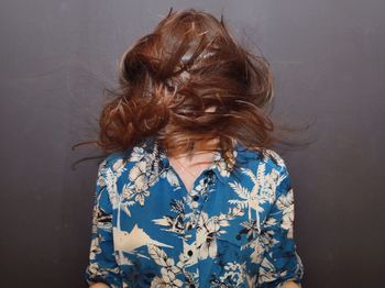 Midsection of woman standing against wall