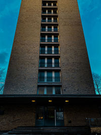 Low angle view of modern building against blue sky