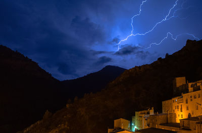 Low angle view of mountain against sky at night