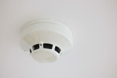 Low angle view of electric lamp against white background