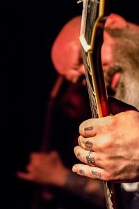 Close-up of man playing guitar