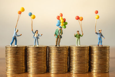 Stack of balloons against wall against white background