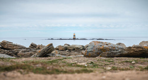 Rocks on beach against sky